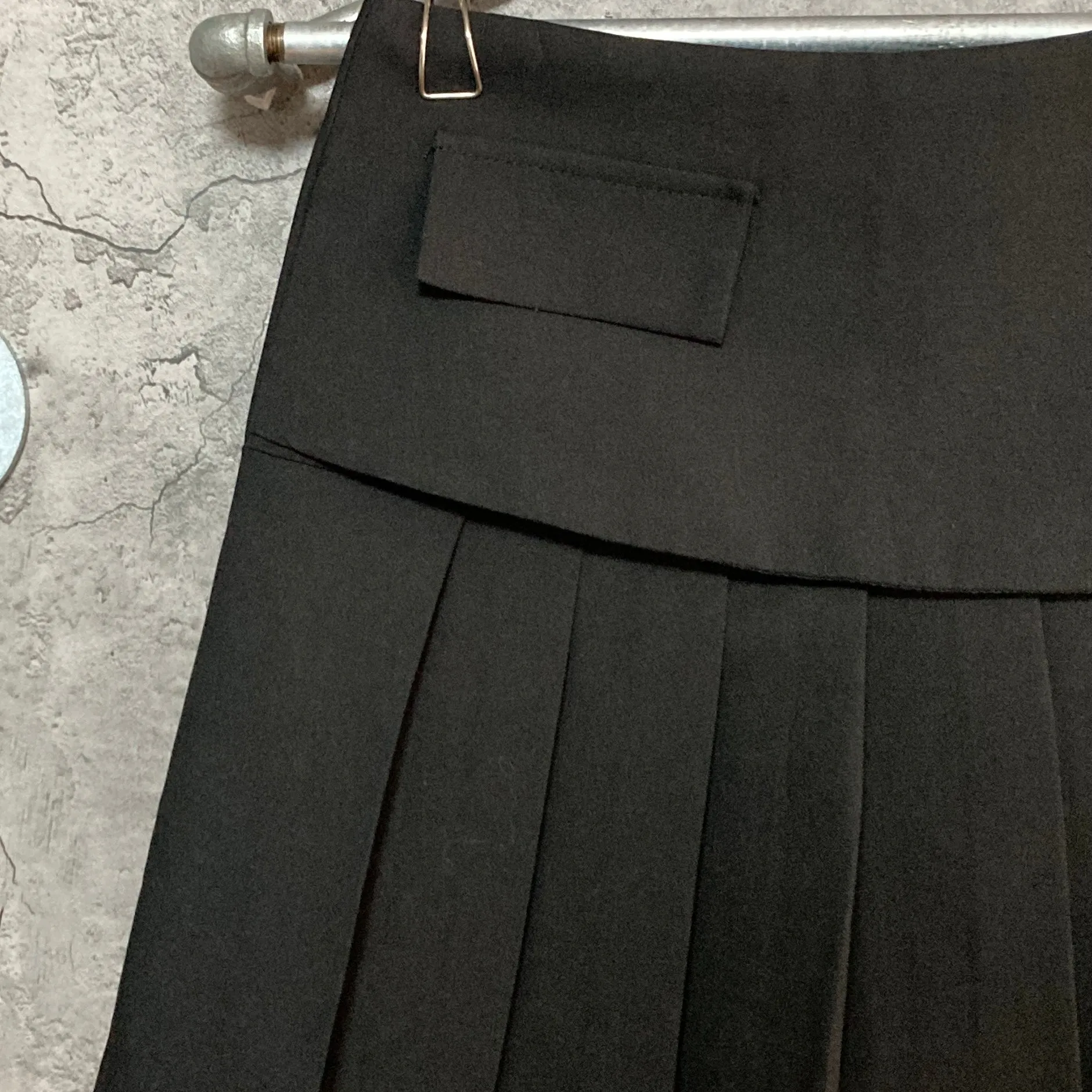 black pleated mini skirt